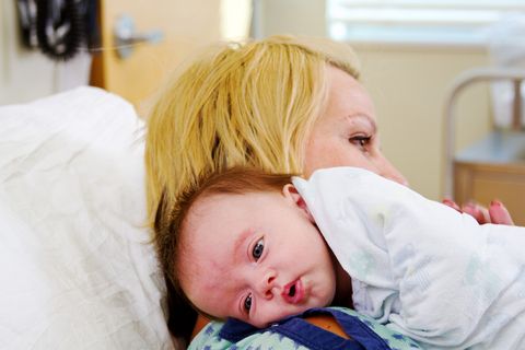 newborn breastfeeding, happy breastfeeding, baby holding the breast while breastfeeding