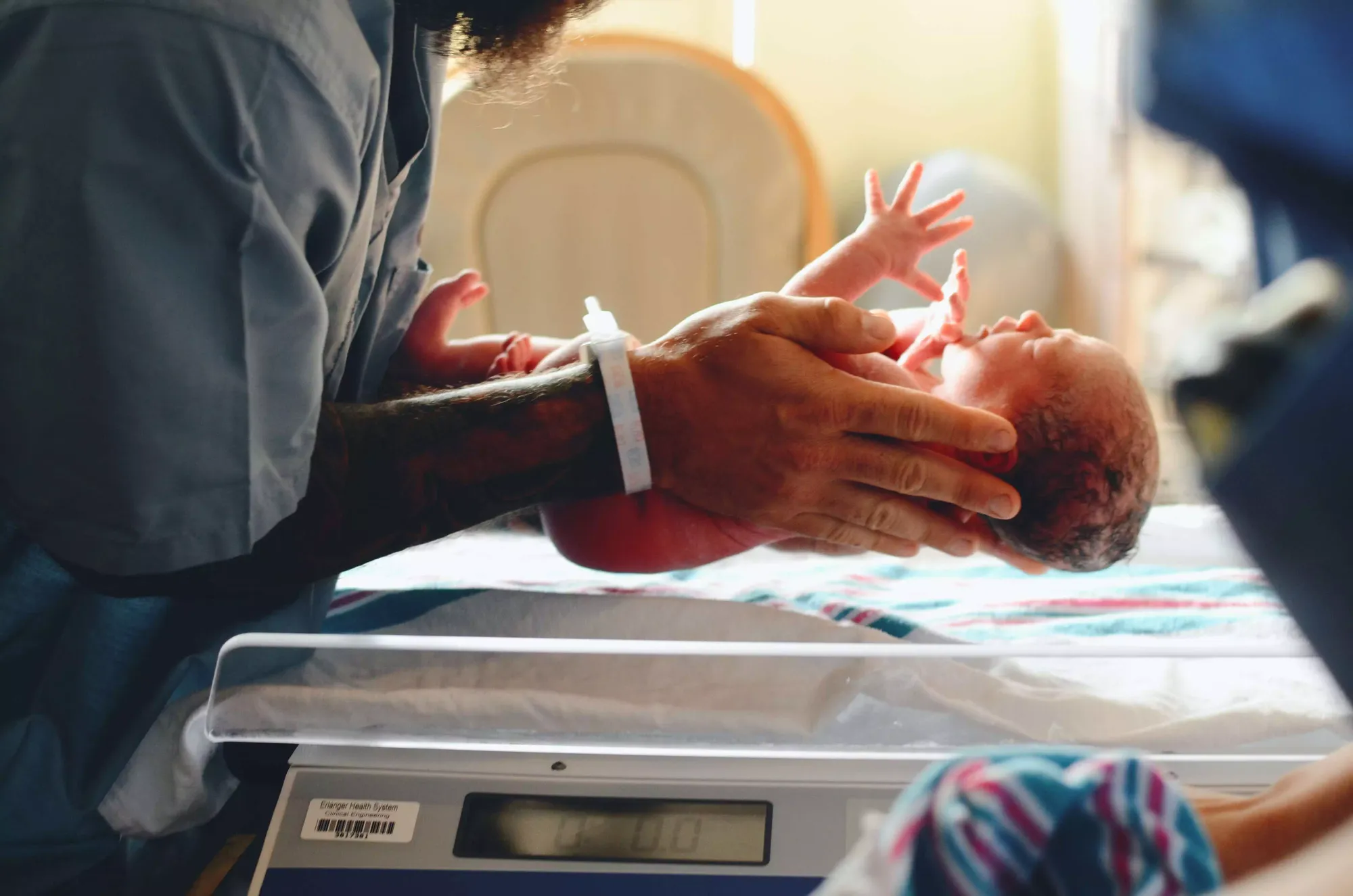 baby being weighed, baby on scale