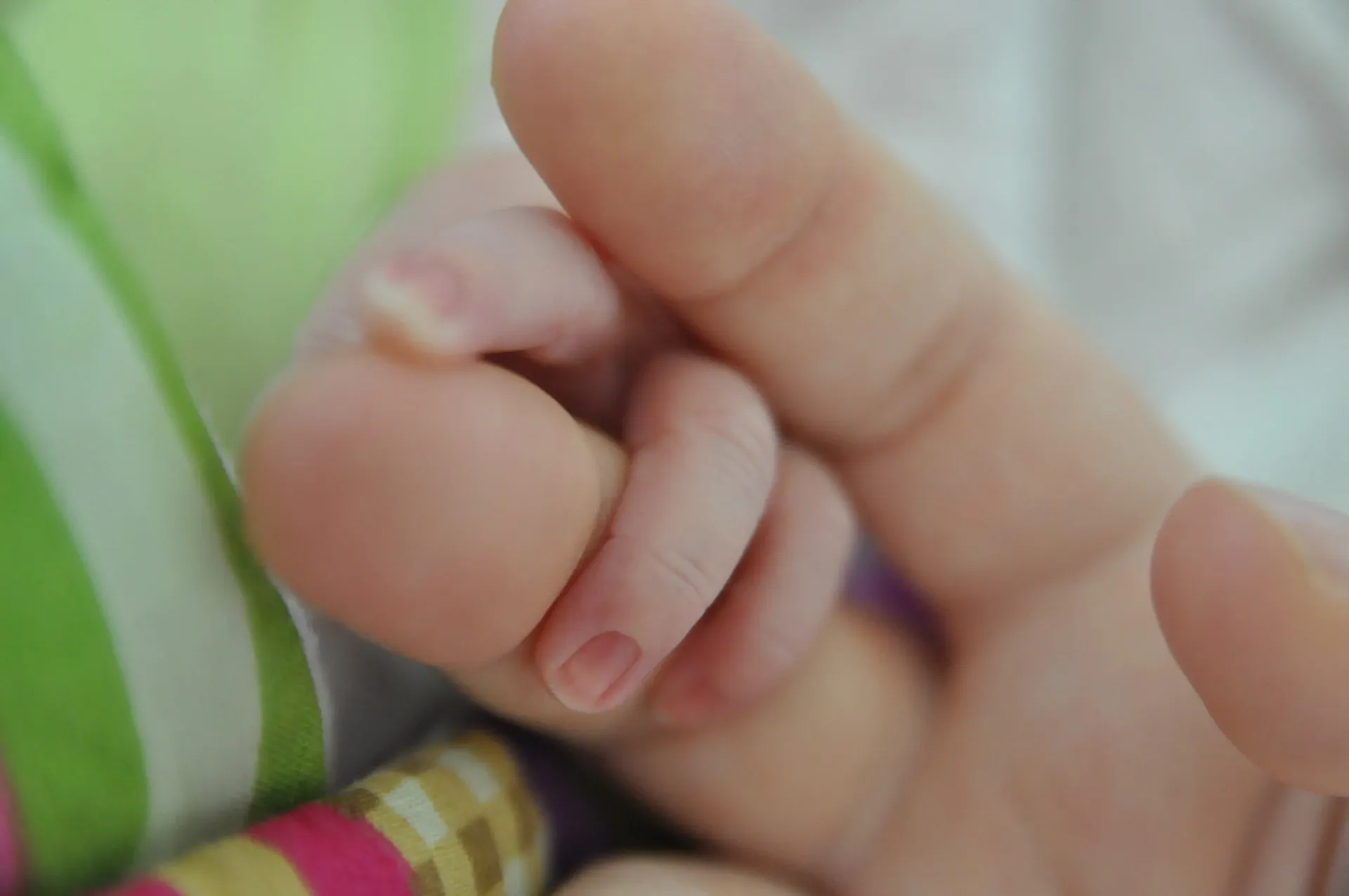 baby hands, baby holding a finger, tiny fingers