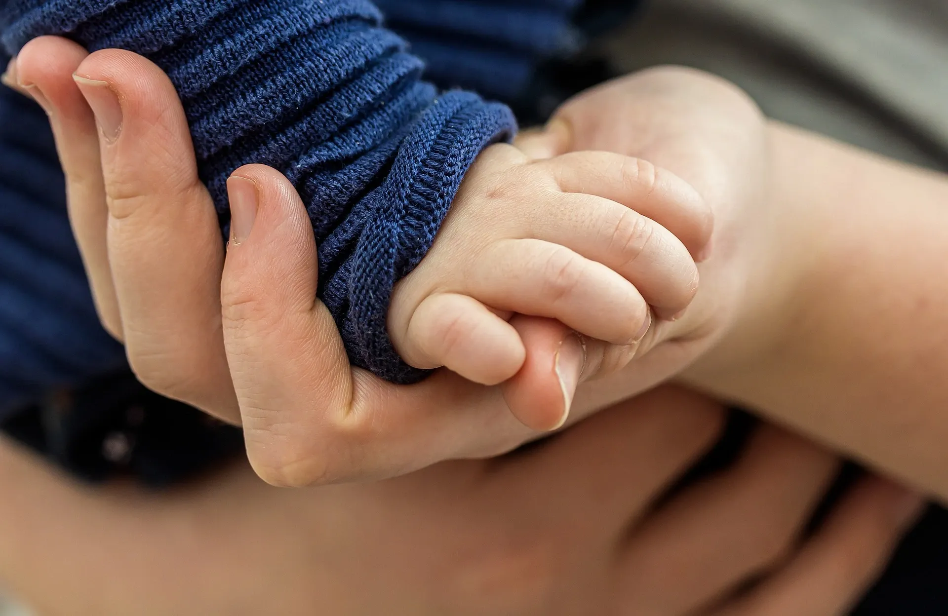 cute baby hand, mom holdng baby's hand