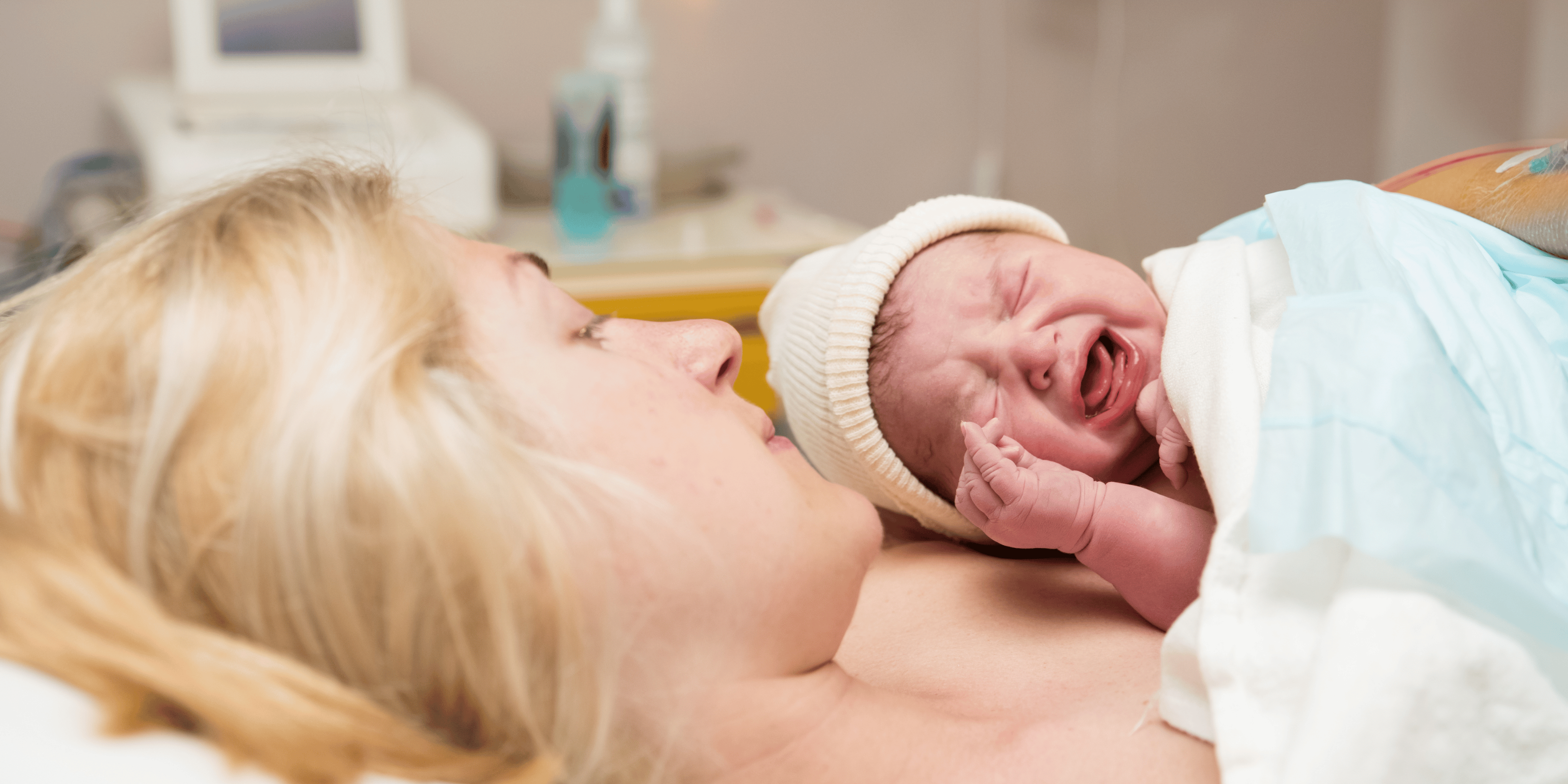 crying baby in mother's arms, baby with colic, baby with gas