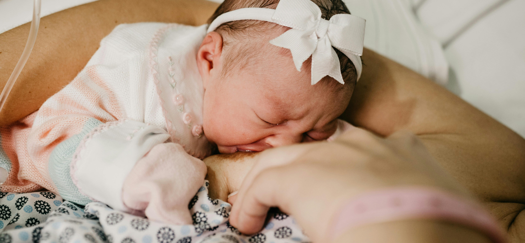 Tiny baby breastfeeding