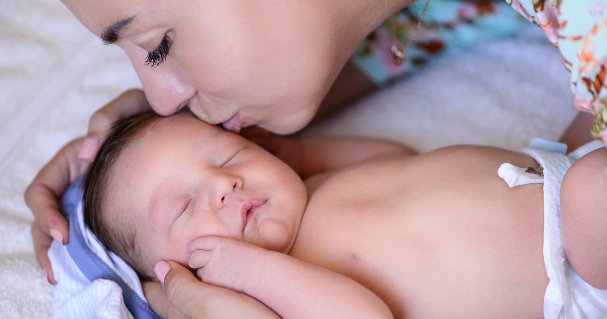 Mom kissing her baby