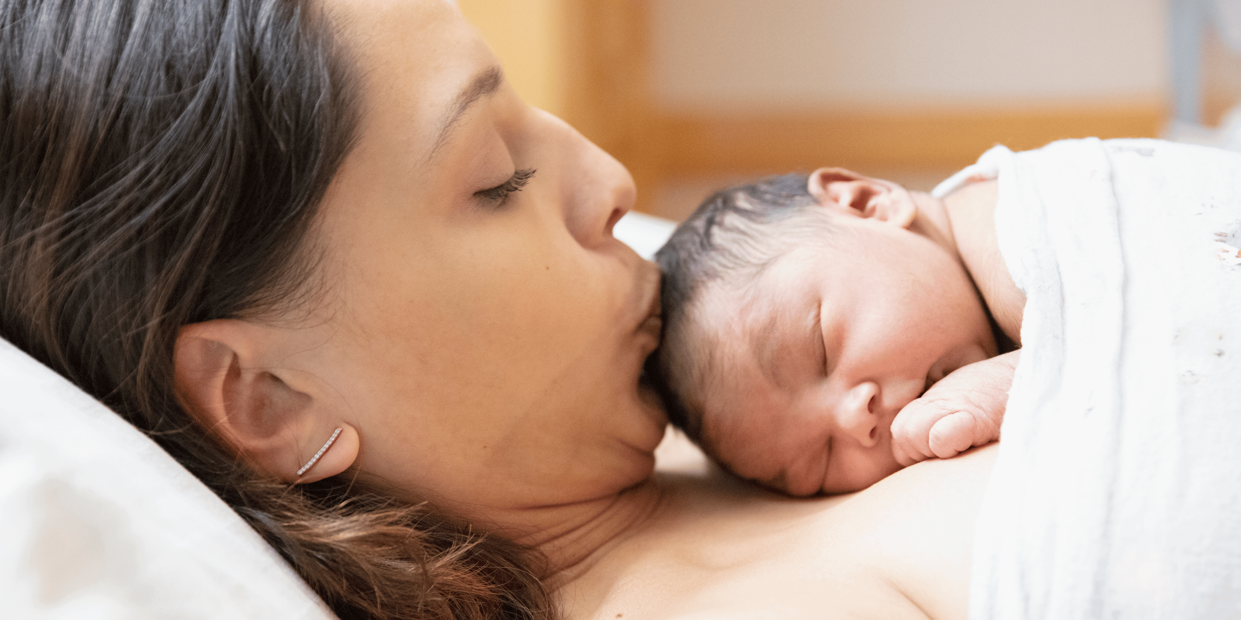 newborn baby lying on mother, baby and mother