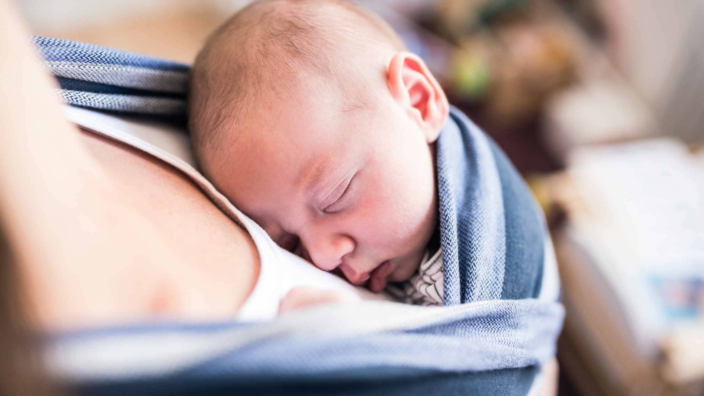 Babywearing, baby in a sling, baby sleeping in a sling