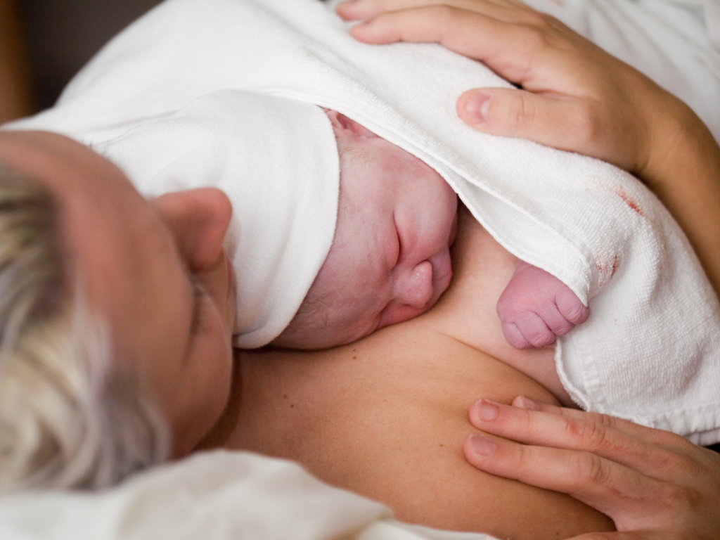 newborn baby lying skin-to-skin with mom