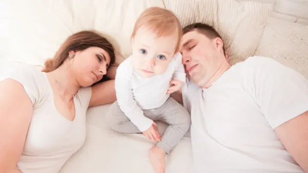 mom and dad, baby with mom and dad in bed
