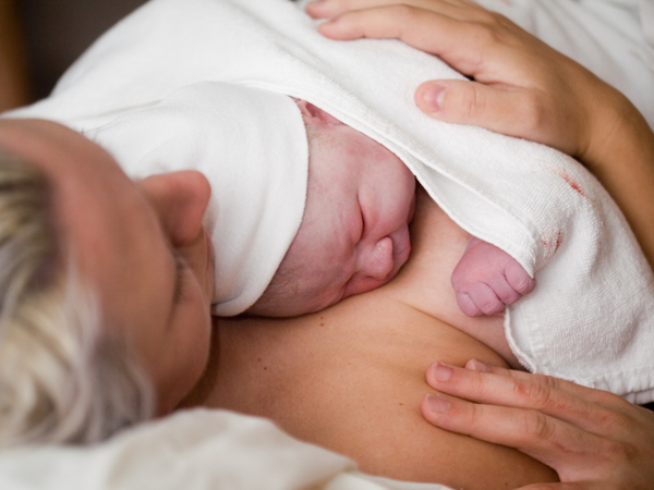 newborn baby lying skin-to-skin with mom