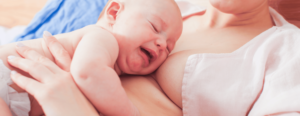baby crying while lying on mom skin-to-skin