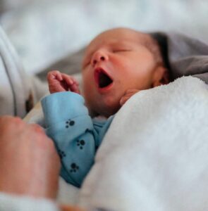 cute newborn baby with mouth wide open