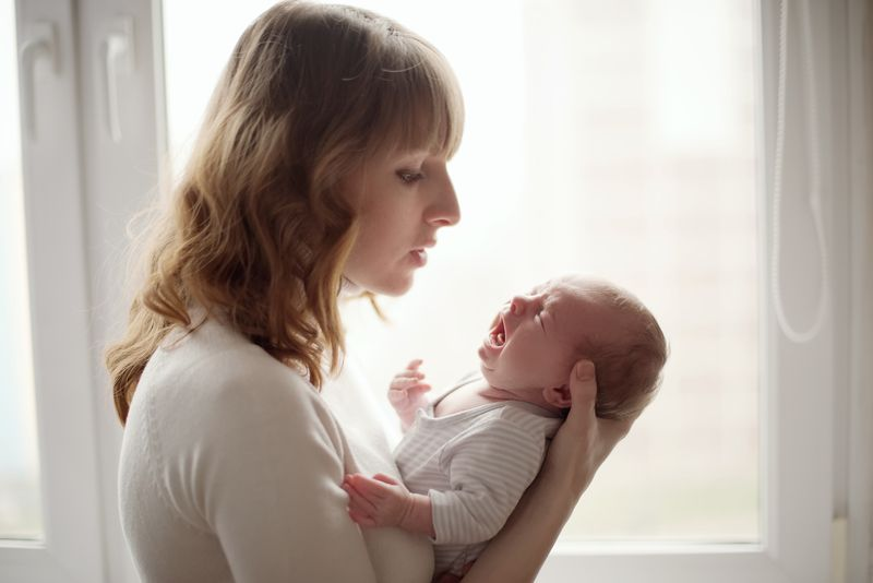 mom holding baby